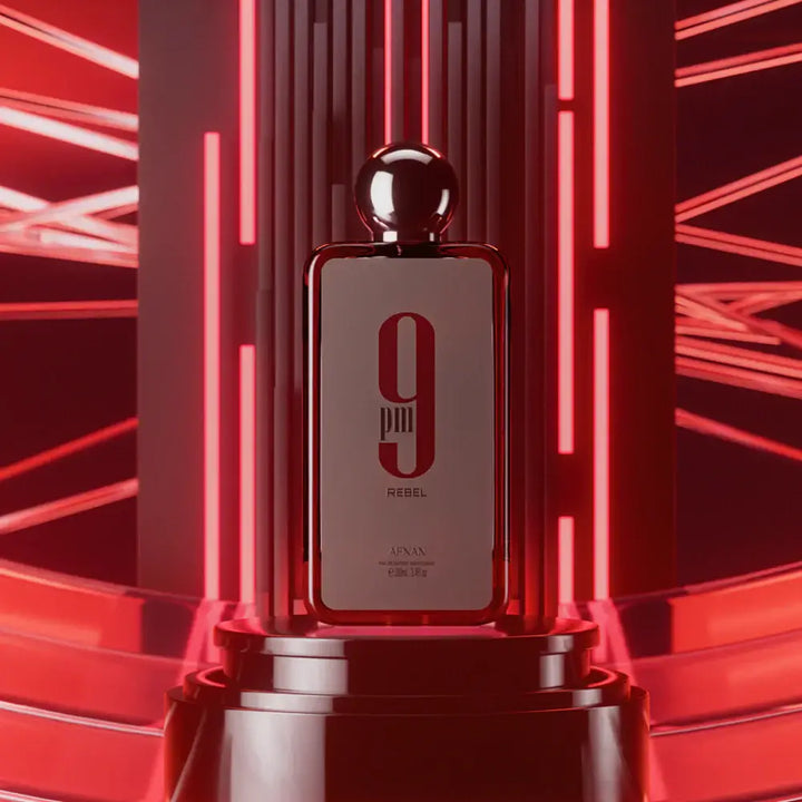 9 PM Rebel perfume bottle elegantly displayed with vibrant red lighting and modern design.